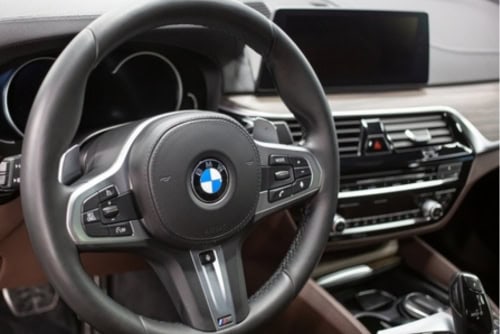 BMW Cooling System Repair in Elkhart, IN with Quality Import Services. Image of BMW X5 steering wheel and dashboard showing the bmw aircon and panel.