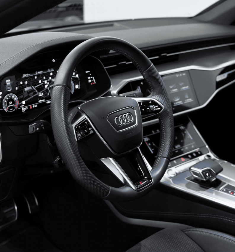 German auto repair and maintenance in Elkhart, IN with Quality Import Services. Image of the interior details of a 2018 Audi A7, showcasing the steering wheel and cockpit.